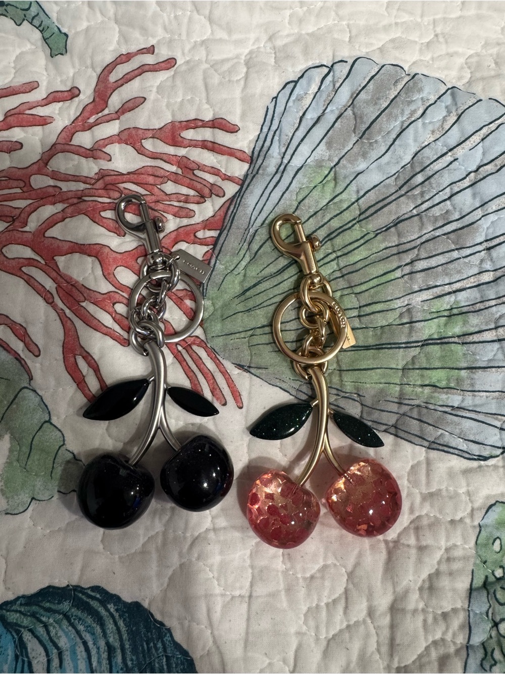 Coach black cherry charm and red cherry charm